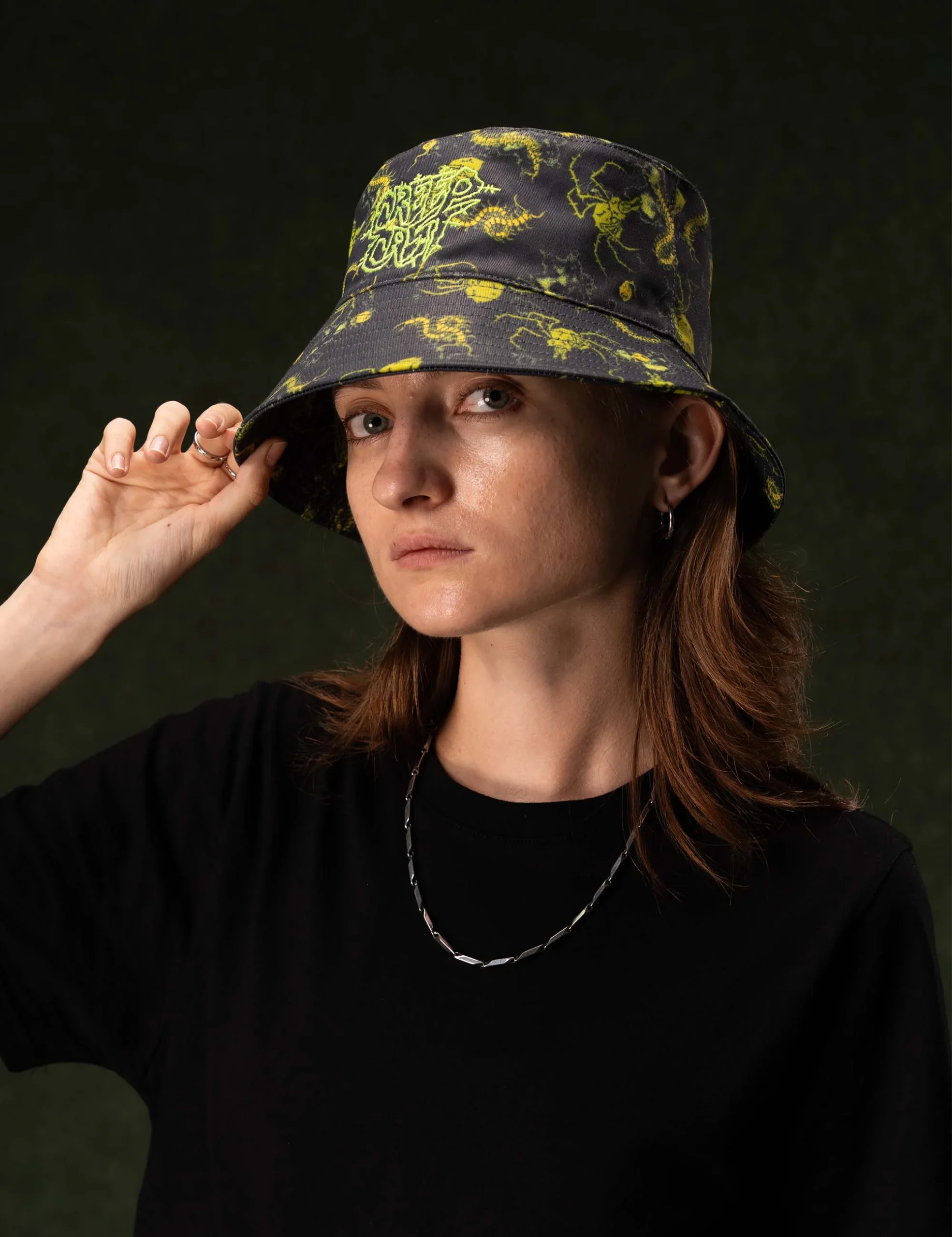 Close-up texture of the fabric weave and reinforced stitching on the Creepy Crawlies Green Bucket Hat - Creep Cast Merch