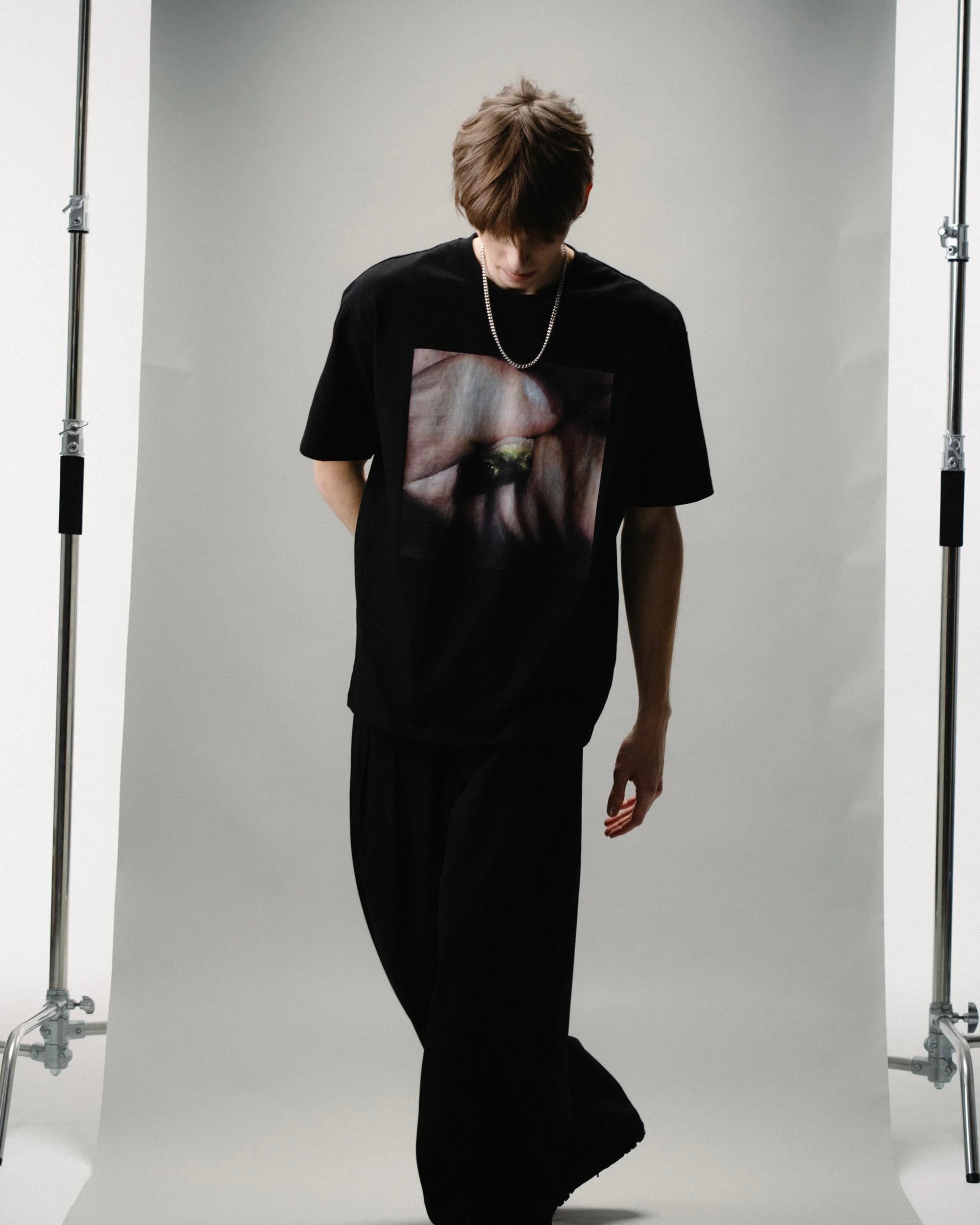 Angled laydown showcasing garment drape and sleeve finishing on the Special Guest Podcast Tshirt Tee - Creep Cast Merch