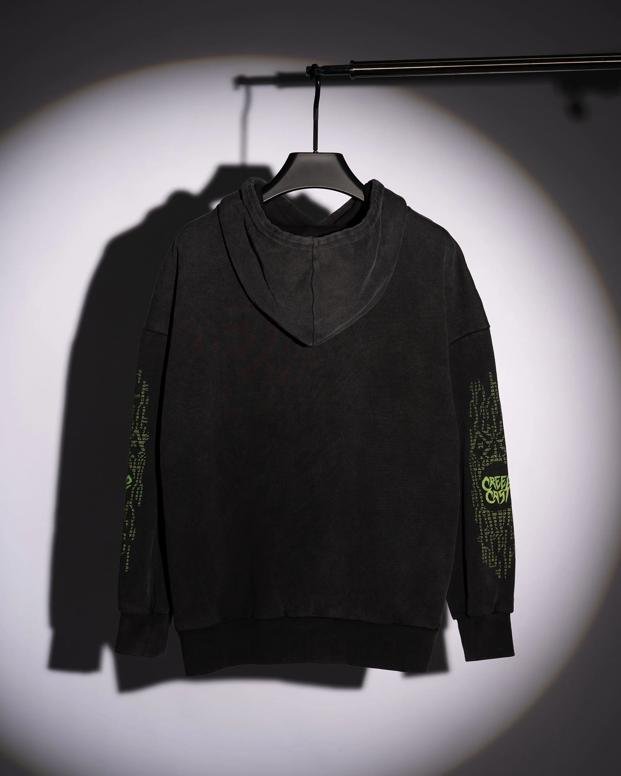 Angled laydown showcasing garment drape and sleeve finishing on the Who Up Creepin Pullover Hoodie Top - Creep Cast Merch